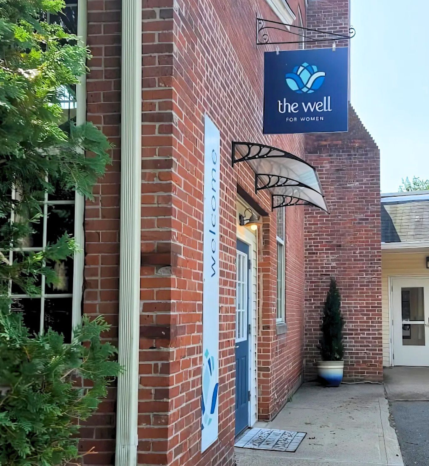 women's wellness building with red bricks and blue sign